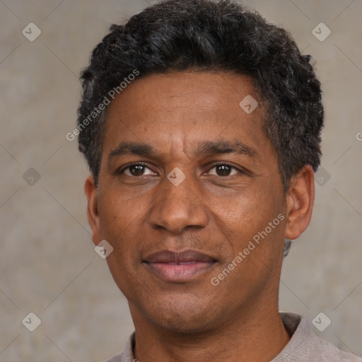 Joyful black adult male with short  black hair and brown eyes