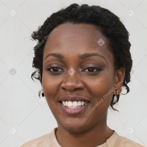 Joyful black young-adult female with short  black hair and brown eyes