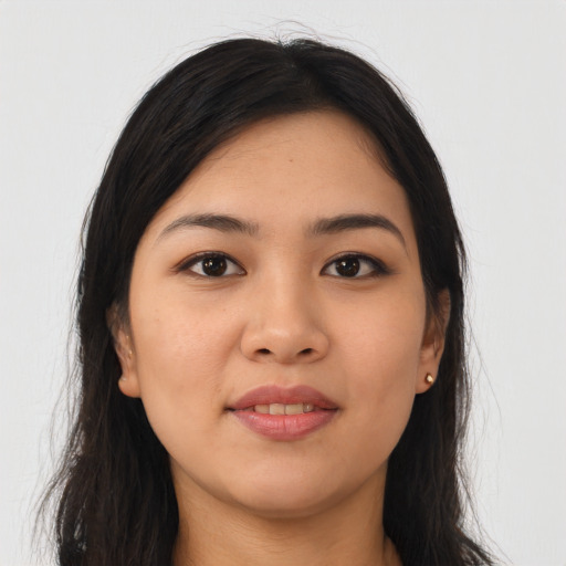 Joyful asian young-adult female with long  brown hair and brown eyes
