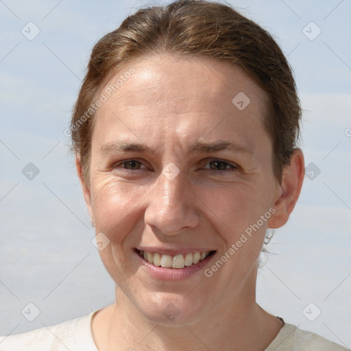 Joyful white adult female with short  brown hair and grey eyes