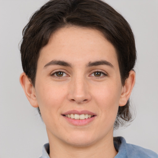 Joyful white young-adult female with medium  brown hair and brown eyes