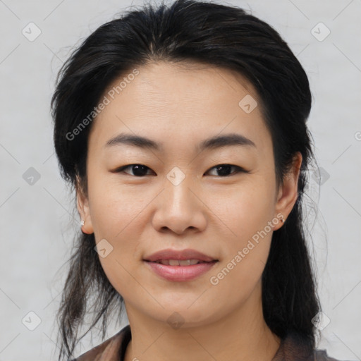 Joyful asian young-adult female with medium  black hair and brown eyes