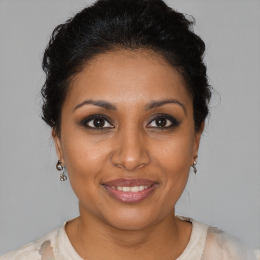 Joyful black young-adult female with medium  brown hair and brown eyes
