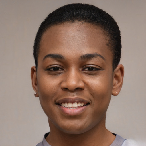 Joyful black young-adult female with short  black hair and brown eyes
