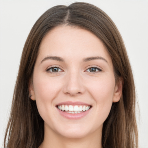 Joyful white young-adult female with long  brown hair and grey eyes