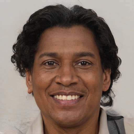 Joyful black adult male with short  brown hair and brown eyes