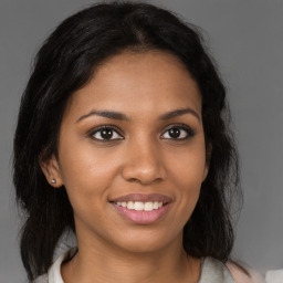 Joyful black young-adult female with medium  brown hair and brown eyes