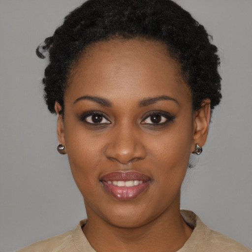 Joyful black young-adult female with short  black hair and brown eyes