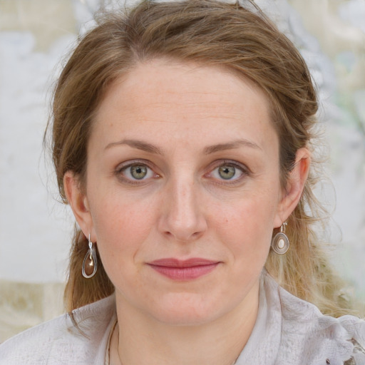 Joyful white young-adult female with medium  brown hair and blue eyes