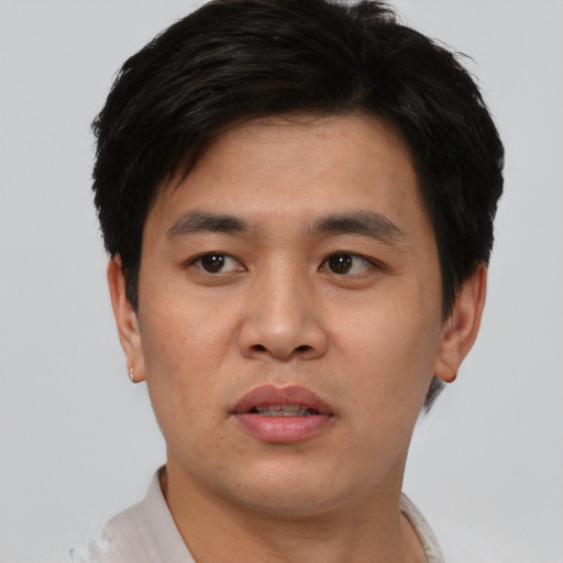 Joyful asian young-adult male with short  black hair and brown eyes