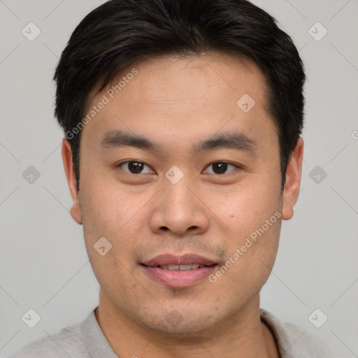 Joyful asian young-adult male with short  brown hair and brown eyes