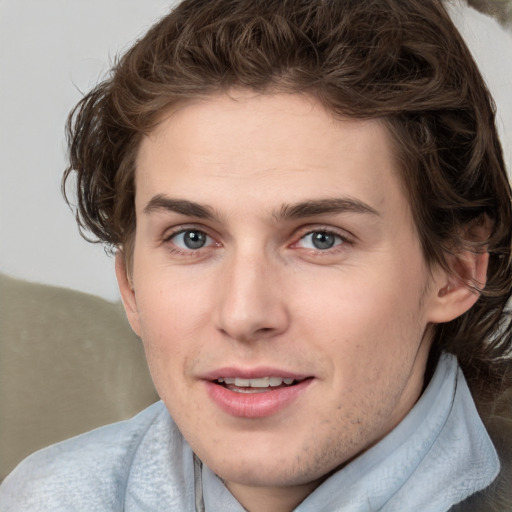 Joyful white young-adult male with medium  brown hair and blue eyes