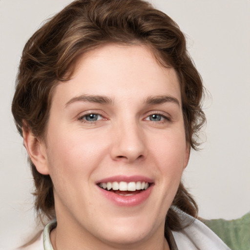 Joyful white young-adult female with medium  brown hair and blue eyes