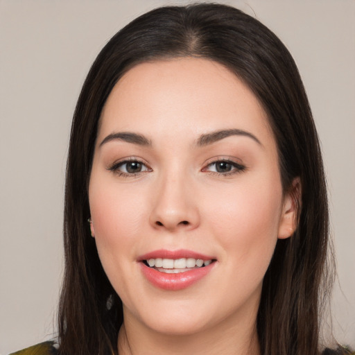 Joyful white young-adult female with long  black hair and brown eyes