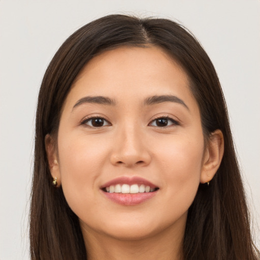 Joyful white young-adult female with long  brown hair and brown eyes