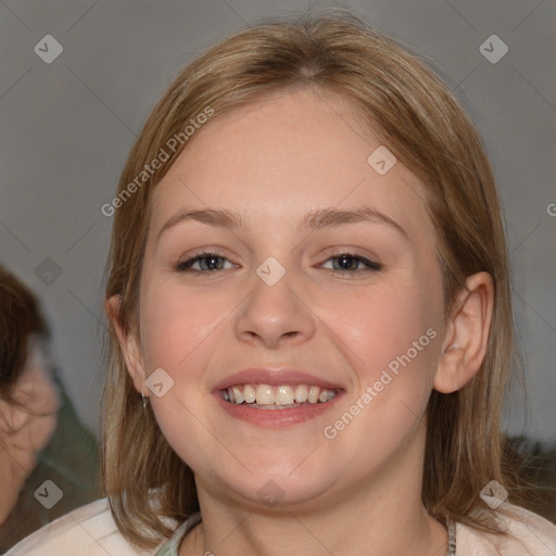 Joyful white young-adult female with medium  brown hair and blue eyes