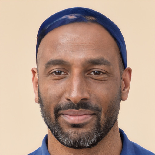 Joyful black adult male with short  black hair and brown eyes