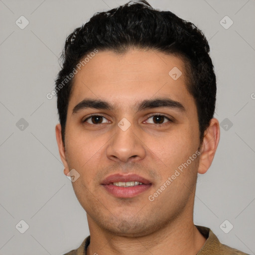 Joyful white young-adult male with short  black hair and brown eyes