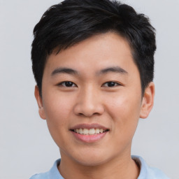 Joyful asian young-adult male with short  brown hair and brown eyes