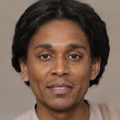 Joyful latino adult male with short  brown hair and brown eyes