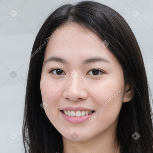 Joyful asian young-adult female with long  brown hair and brown eyes