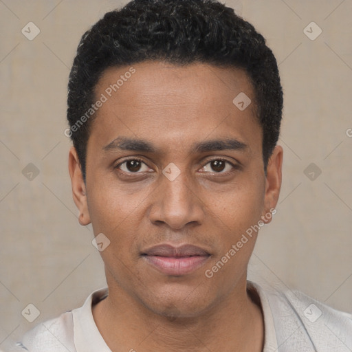 Joyful black young-adult male with short  black hair and brown eyes