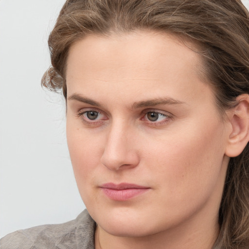 Joyful white young-adult female with long  brown hair and grey eyes