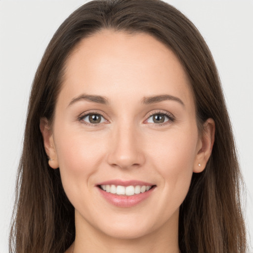 Joyful white young-adult female with long  brown hair and grey eyes