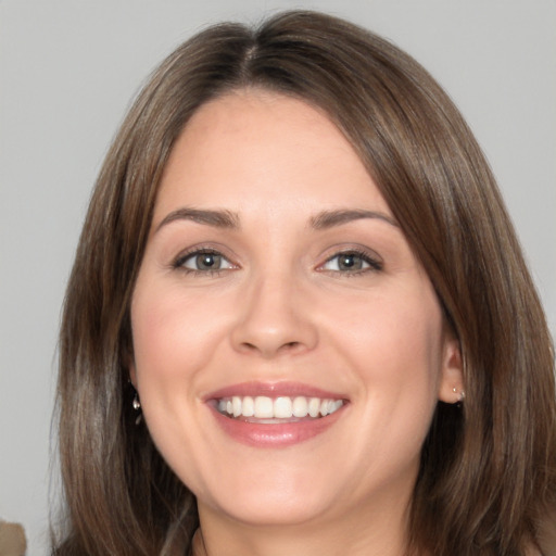 Joyful white adult female with medium  brown hair and brown eyes