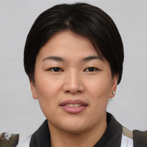 Joyful asian young-adult female with medium  black hair and brown eyes