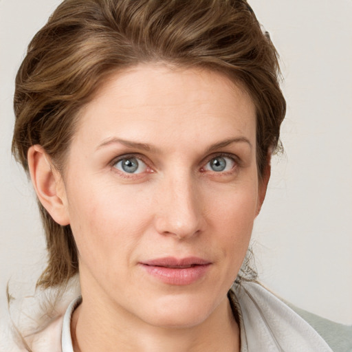 Joyful white young-adult female with medium  brown hair and blue eyes