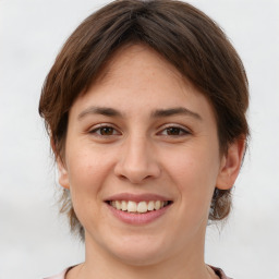 Joyful white young-adult female with medium  brown hair and brown eyes