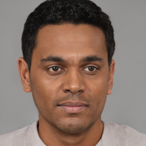 Neutral black young-adult male with short  black hair and brown eyes