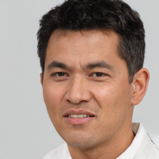 Joyful white adult male with short  black hair and brown eyes