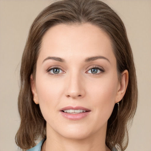 Joyful white young-adult female with medium  brown hair and green eyes