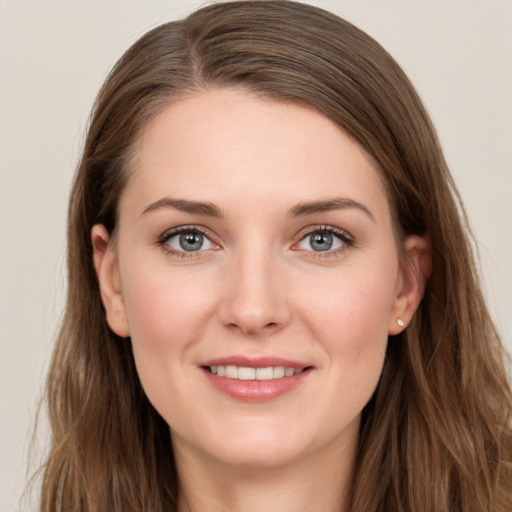 Joyful white young-adult female with long  brown hair and grey eyes