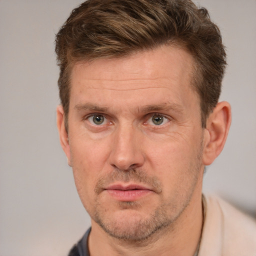 Joyful white adult male with short  brown hair and grey eyes