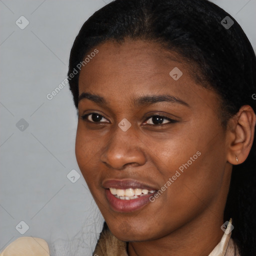 Joyful black young-adult female with short  black hair and brown eyes