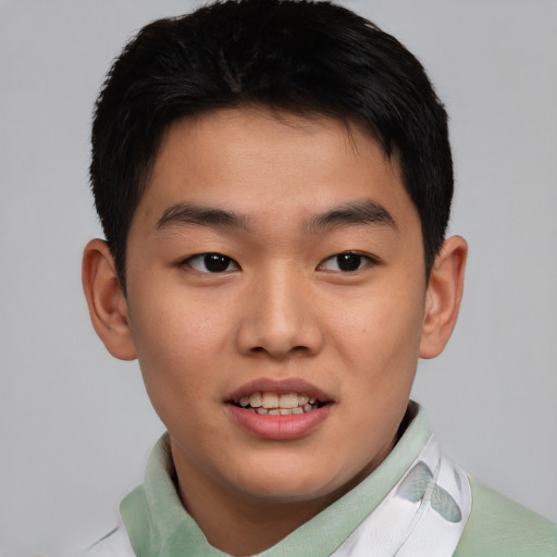 Joyful asian young-adult male with short  brown hair and brown eyes