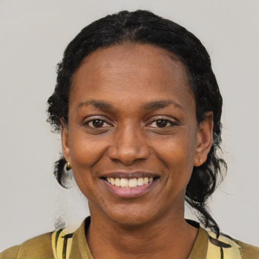 Joyful black adult female with short  black hair and brown eyes