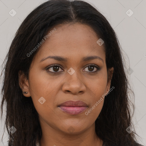 Joyful black young-adult female with long  brown hair and brown eyes
