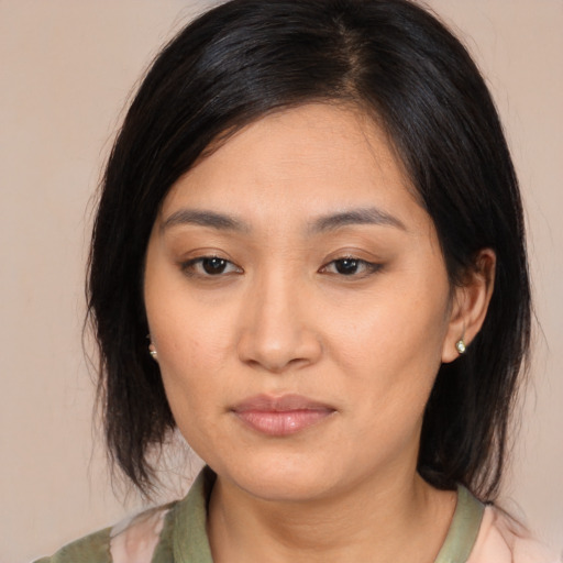 Joyful asian young-adult female with medium  brown hair and brown eyes