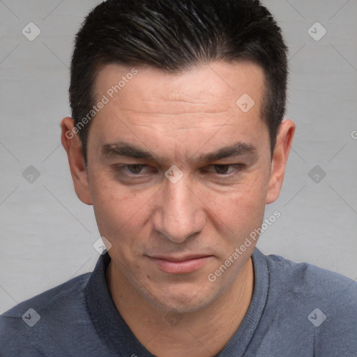 Joyful white adult male with short  black hair and brown eyes