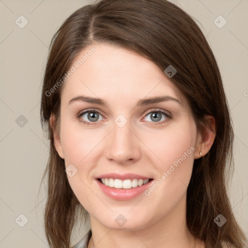 Joyful white young-adult female with medium  brown hair and green eyes