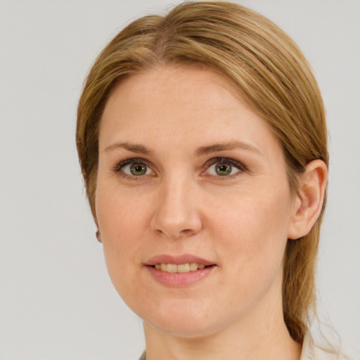 Joyful white adult female with medium  brown hair and green eyes