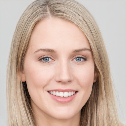 Joyful white young-adult female with long  brown hair and blue eyes