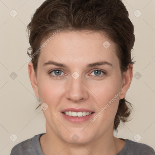 Joyful white young-adult female with short  brown hair and grey eyes