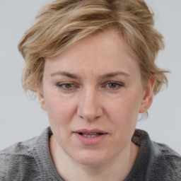 Joyful white adult female with medium  brown hair and blue eyes