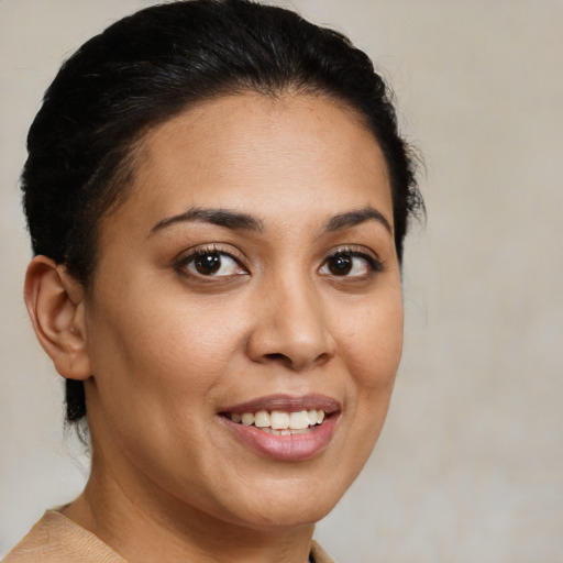 Joyful latino young-adult female with medium  brown hair and brown eyes