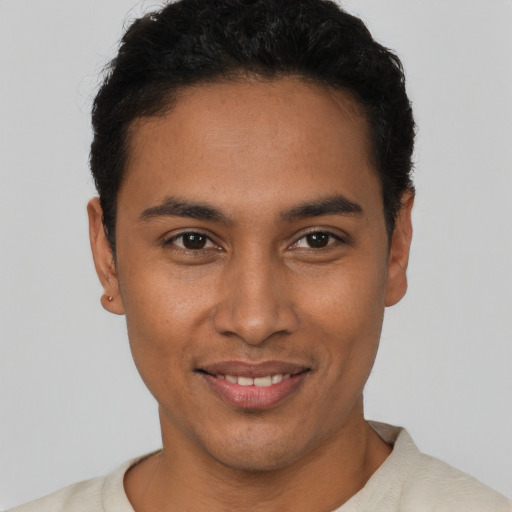 Joyful latino young-adult male with short  black hair and brown eyes